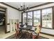 Bright breakfast nook with a black table, chairs, and large windows overlooking the lawn at 2122 Pleasant Hill Rd, Rocky Mount, NC 27801