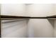 Empty closet with shelves and dark wood trim at 2122 Pleasant Hill Rd, Rocky Mount, NC 27801