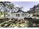 Charming two-story home with a covered front porch and well-maintained lawn and mature trees at 2122 Pleasant Hill Rd, Rocky Mount, NC 27801