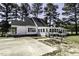 Exterior of a home with white siding, a manicured lawn, and mature trees at 2122 Pleasant Hill Rd, Rocky Mount, NC 27801