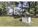 Picturesque exterior with lush greenery, a private well and a charming cottage-style home at 2122 Pleasant Hill Rd, Rocky Mount, NC 27801