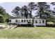 Exterior of a home with white siding, a manicured lawn, and mature trees at 2122 Pleasant Hill Rd, Rocky Mount, NC 27801