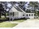 Charming house with white siding, a covered porch, and a well-maintained front yard with mature trees at 2122 Pleasant Hill Rd, Rocky Mount, NC 27801