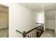 Bright hallway with wooden railing and carpeted floor at 2122 Pleasant Hill Rd, Rocky Mount, NC 27801
