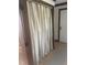 View of a hallway with a curtained off closet area with wooden trim and flooring at 2122 Pleasant Hill Rd, Rocky Mount, NC 27801