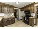 Kitchen boasts wood cabinets, laminate floors, black appliances, and bright lighting fixtures at 2122 Pleasant Hill Rd, Rocky Mount, NC 27801