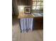 Cozy kitchen features a charming curtain covering the space for the dishwasher with a bright window view at 2122 Pleasant Hill Rd, Rocky Mount, NC 27801