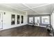 Bright sunroom featuring dark wood-look floors, light walls and a ceiling fan at 2122 Pleasant Hill Rd, Rocky Mount, NC 27801