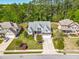 An aerial view showcasing a well-maintained home with a manicured lawn, mature trees, and a two-car garage at 215 Terrell Dr, Rolesville, NC 27571