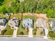 A bird's eye view of a home featuring mature trees, a fenced backyard, and a well-kept lawn in a suburban setting at 215 Terrell Dr, Rolesville, NC 27571