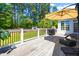 Wide deck with seating, grill, and umbrella overlooks a fenced yard with lush greenery, perfect for outdoor enjoyment at 215 Terrell Dr, Rolesville, NC 27571