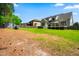 Expansive backyard with lush lawn, patio, shed, and mature trees for outdoor entertaining and relaxation at 215 Terrell Dr, Rolesville, NC 27571