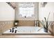 This bathroom boasts a drop-in tub, tile surround, and a window for natural light at 215 Terrell Dr, Rolesville, NC 27571