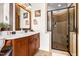 Bright bathroom featuring a wood vanity with a white countertop and glass-enclosed shower with tile at 215 Terrell Dr, Rolesville, NC 27571