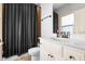 Bathroom featuring a dark-striped shower curtain, vanity and modern fixtures at 215 Terrell Dr, Rolesville, NC 27571