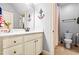 Inviting bathroom featuring a toilet, vanity, and shower with neutral tones at 215 Terrell Dr, Rolesville, NC 27571