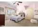 Cozy pink bedroom with a dormer window, ceiling fan, and plush neutral carpet flooring at 215 Terrell Dr, Rolesville, NC 27571