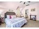 Cozy bedroom features plush bedding, soft pink walls, and a connecting bathroom at 215 Terrell Dr, Rolesville, NC 27571