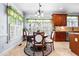 Bright breakfast nook with large windows, shutters, and a charming chandelier above the table at 215 Terrell Dr, Rolesville, NC 27571