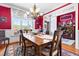 Charming dining room featuring a wooden table, elegant chandelier, and large windows overlooking the outdoor scenery at 215 Terrell Dr, Rolesville, NC 27571