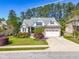 Beautiful single-Gathering home with a well-manicured lawn, colorful shrubs, and a convenient two-car garage in a quiet neighborhood at 215 Terrell Dr, Rolesville, NC 27571