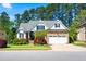 Charming home featuring manicured landscaping, a two-car garage, and stone accents on the exterior at 215 Terrell Dr, Rolesville, NC 27571