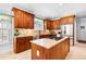 Well-lit kitchen featuring a center island, granite countertops, and stainless steel appliances at 215 Terrell Dr, Rolesville, NC 27571
