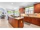 Open kitchen featuring an island cooktop, stone countertops, and tiled flooring near the breakfast nook at 215 Terrell Dr, Rolesville, NC 27571