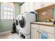 Well-lit laundry room featuring front load washer and dryer and upper and lower cabinets at 215 Terrell Dr, Rolesville, NC 27571