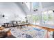 Spacious living room with large windows, vaulted ceilings, and comfortable seating, ideal for relaxation at 215 Terrell Dr, Rolesville, NC 27571