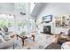 Inviting living room featuring a fireplace, built-in shelving, and large windows overlooking the backyard at 215 Terrell Dr, Rolesville, NC 27571