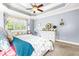 Cozy main bedroom with neutral carpeting, a decorative ceiling fan, and natural light at 215 Terrell Dr, Rolesville, NC 27571