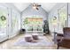 Bright sunroom filled with natural light, comfortable seating, and tile floors at 215 Terrell Dr, Rolesville, NC 27571