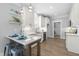 Modern white kitchen with granite countertops, stainless steel appliances, tiled backsplash, and wood flooring at 238 W Paige Wynd Dr, Angier, NC 27501