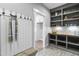 Mudroom features built-in shelving, coat hooks, bench, and wood-look floors at 238 W Paige Wynd Dr, Angier, NC 27501