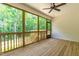 Covered back porch featuring wooden floor, white shiplap, and ceiling fan at 238 W Paige Wynd Dr, Angier, NC 27501