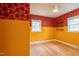 Sun-filled bedroom with natural hardwood floors, decorative wallpaper and a modern ceiling fan at 2506 N Duke St, Durham, NC 27704