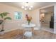Bright dining room with hardwood floors, decorative trim, and a view to laundry room at 2506 N Duke St, Durham, NC 27704