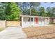 Charming home with a bright red door, inviting front porch and a charming wooden fence at 2506 N Duke St, Durham, NC 27704