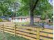 Charming brick home with a spacious front yard, wooden fence and a red door, perfect for curb appeal at 2506 N Duke St, Durham, NC 27704