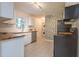 Charming kitchen featuring wood counters, white cabinets, stainless dishwasher and bright wallpaper at 2506 N Duke St, Durham, NC 27704
