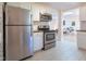 Kitchen with stainless appliances, white cabinets, wood counters and subway tile backsplash at 2506 N Duke St, Durham, NC 27704