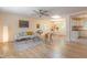 Spacious living room with hardwood floors, a ceiling fan, and abundant natural light, open to a dining area at 2506 N Duke St, Durham, NC 27704
