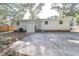 Rear exterior featuring a level driveway, back entrance, and neutral white siding at 2506 N Duke St, Durham, NC 27704