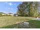 Lush backyard featuring a sprawling lawn and bordered by mature trees, creating a serene outdoor space at 2704 Dove Ln, Raleigh, NC 27604