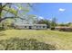 Backyard featuring mature trees and a lush lawn, complete with a patio ideal for outdoor living at 2704 Dove Ln, Raleigh, NC 27604