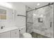 Modern bathroom featuring a tile shower with glass doors and a white vanity at 2704 Dove Ln, Raleigh, NC 27604