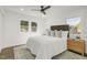 Bedroom with large bed, wood floors, ceiling fan, and large windows at 2704 Dove Ln, Raleigh, NC 27604
