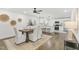 View from dining area to bright white kitchen with marble countertop island at 2704 Dove Ln, Raleigh, NC 27604