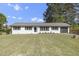 Charming single-story home with a well-manicured lawn and white painted brick at 2704 Dove Ln, Raleigh, NC 27604